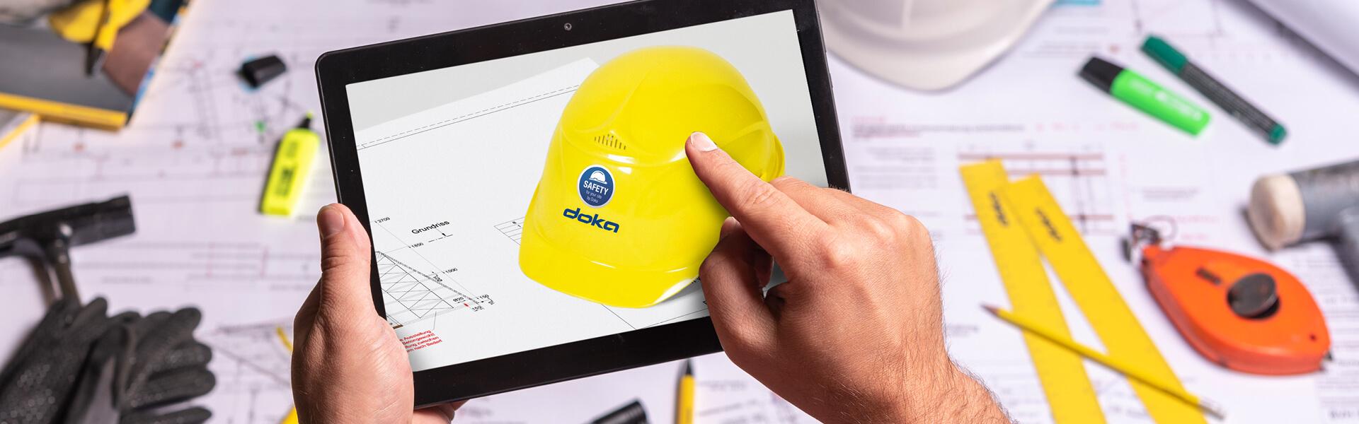 person holding tablet showing Webinars for safety products